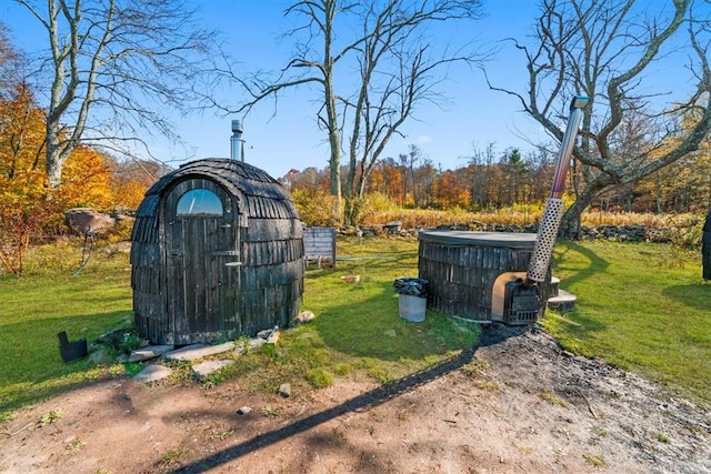 view of outbuilding featuring a yard