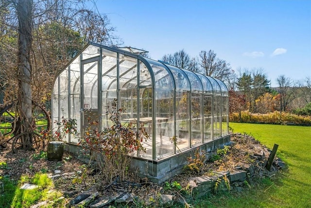 view of outdoor structure featuring a lawn