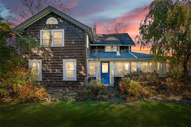 back house at dusk with a yard