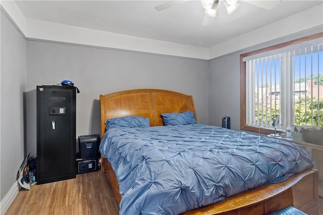 bedroom with hardwood / wood-style floors and ceiling fan