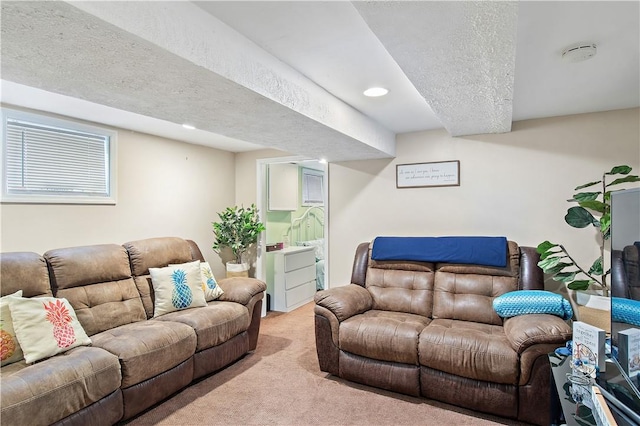 carpeted living room featuring a textured ceiling