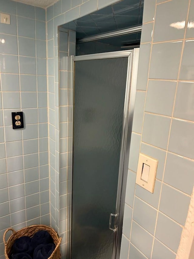 bathroom with a shower with door