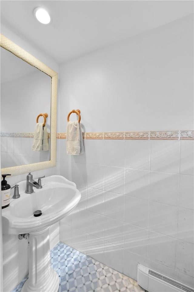 bathroom featuring baseboard heating and tile walls