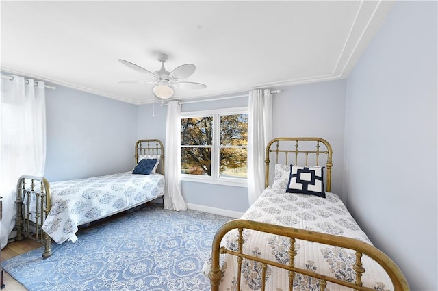 bedroom featuring hardwood / wood-style flooring, ceiling fan, and ornamental molding