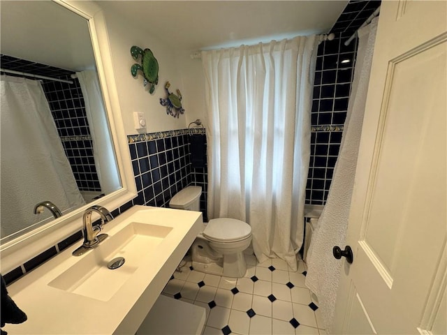 full bathroom featuring sink, shower / tub combo, tile walls, and toilet