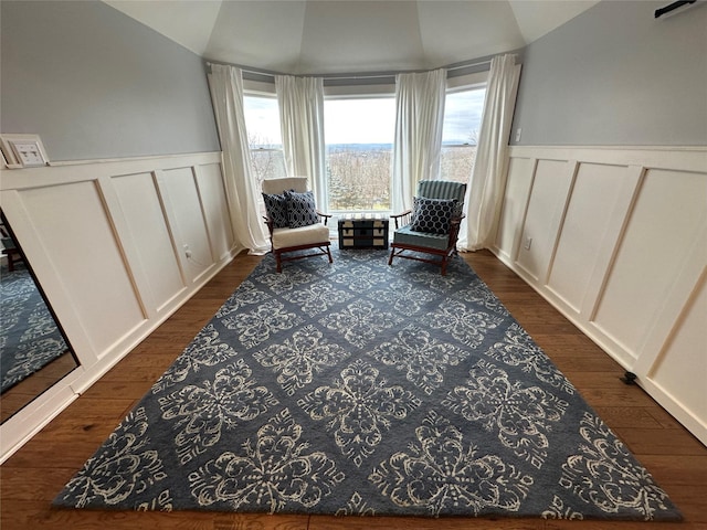 sitting room featuring vaulted ceiling and dark wood-type flooring