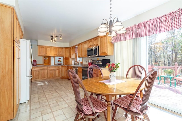 dining room with sink and an inviting chandelier