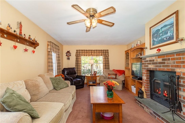 carpeted living room with ceiling fan and a fireplace