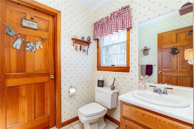 bathroom with tile patterned flooring, vanity, and toilet