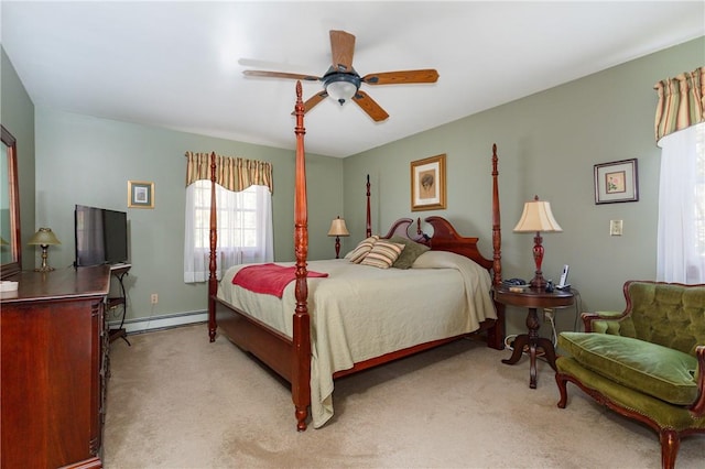 bedroom with ceiling fan, light colored carpet, and a baseboard heating unit