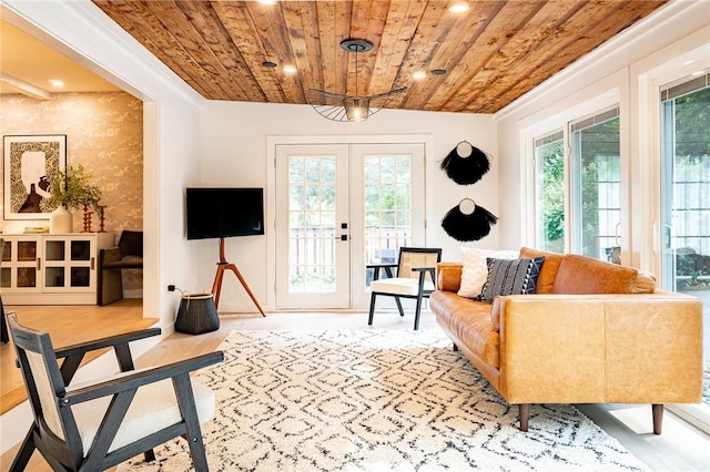 living room with wood ceiling, a wealth of natural light, and french doors