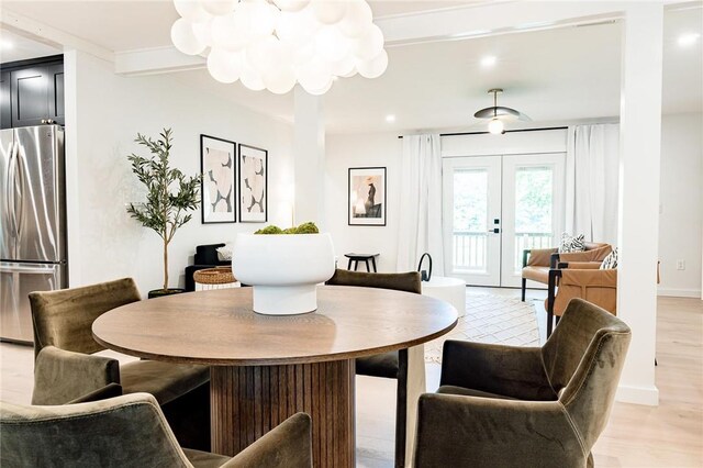 dining area with light hardwood / wood-style flooring and french doors