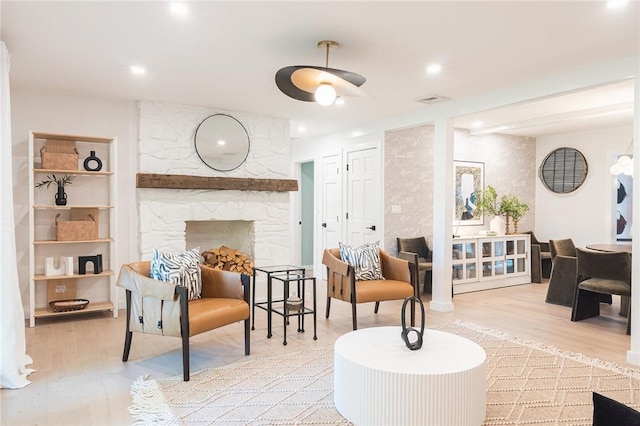 living room with a fireplace and light hardwood / wood-style flooring