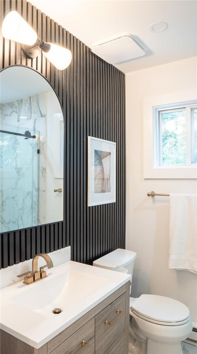 bathroom with a shower, a baseboard heating unit, vanity, and toilet