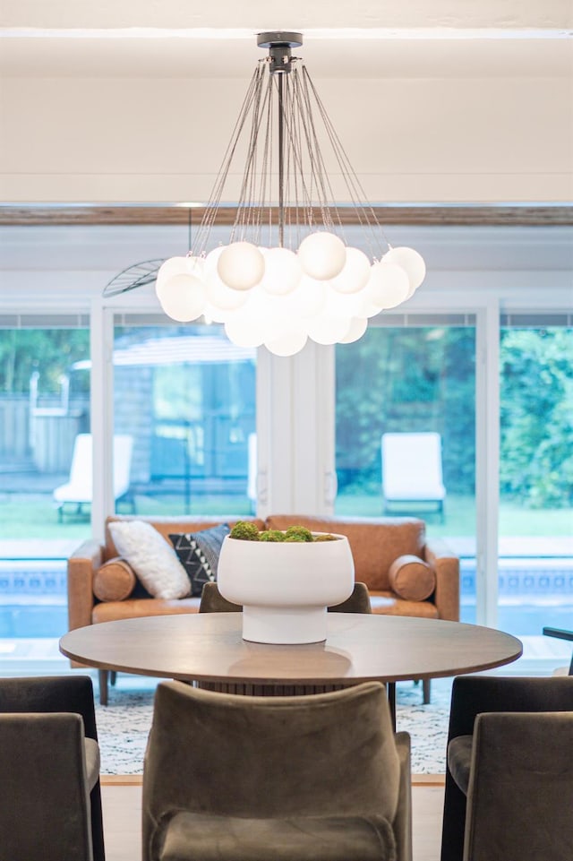 sunroom / solarium with an inviting chandelier and a healthy amount of sunlight