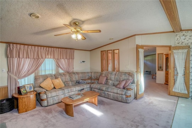 carpeted living room featuring lofted ceiling with beams, ceiling fan, ornamental molding, and a textured ceiling