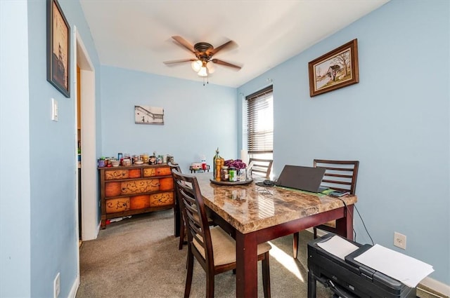 dining area with carpet and ceiling fan