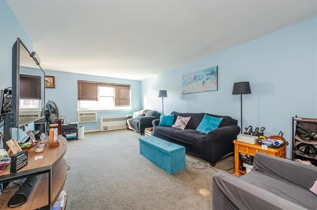 carpeted living room with radiator heating unit