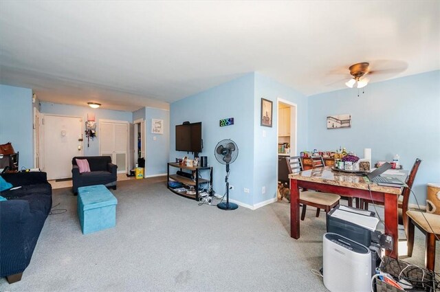 carpeted living room with ceiling fan