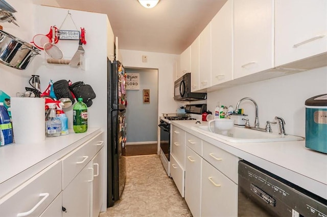 kitchen with black appliances, white cabinets, and sink