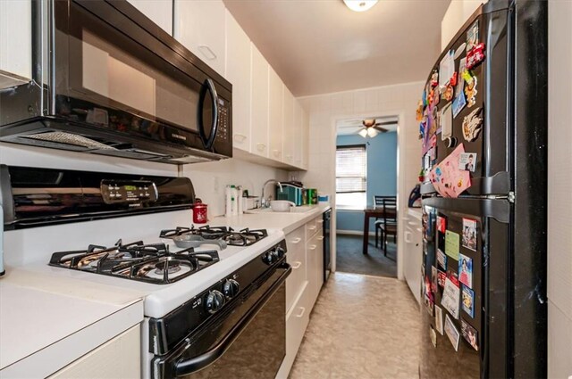 kitchen featuring stainless steel fridge, white cabinets, ceiling fan, sink, and white range with gas stovetop