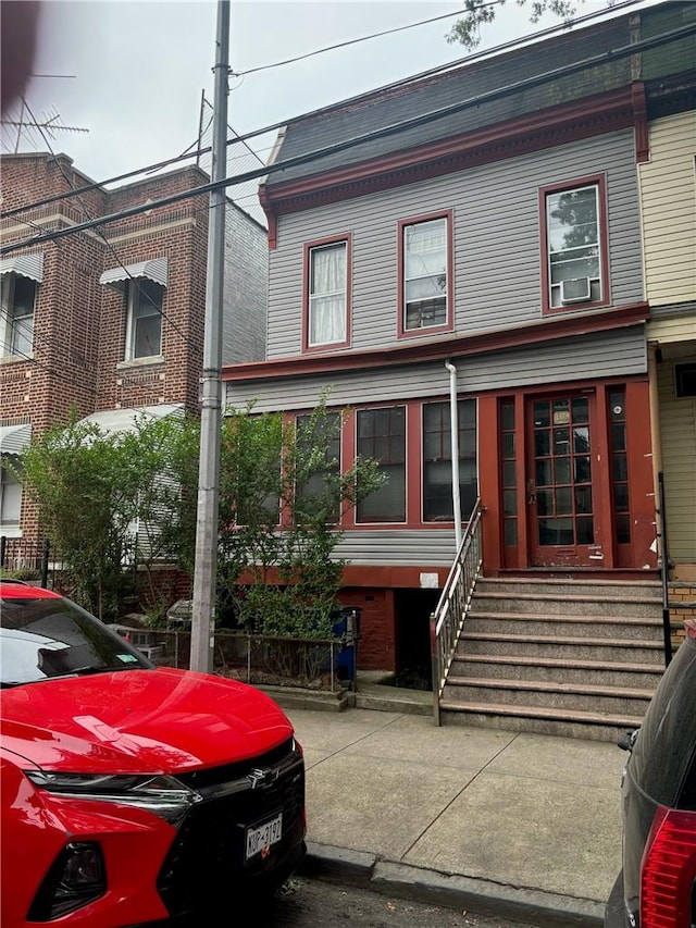 view of front of house featuring cooling unit