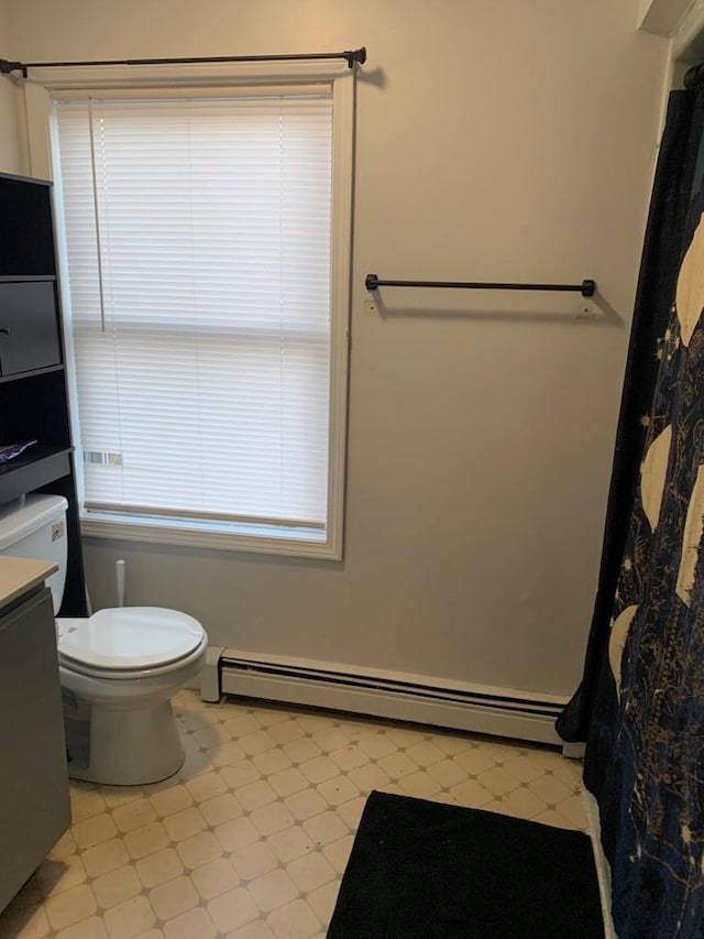 bathroom featuring vanity, toilet, and a baseboard radiator