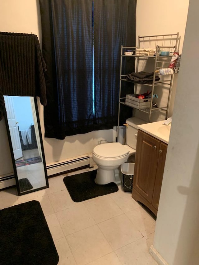 bathroom with tile patterned floors, vanity, toilet, and baseboard heating