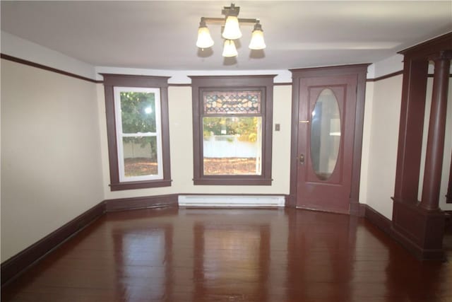 entrance foyer with a notable chandelier, dark wood-type flooring, and a baseboard radiator