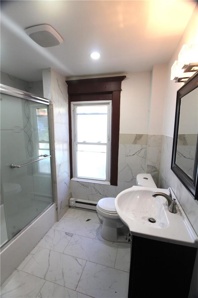 bathroom with baseboard heating, vanity, tile walls, and toilet