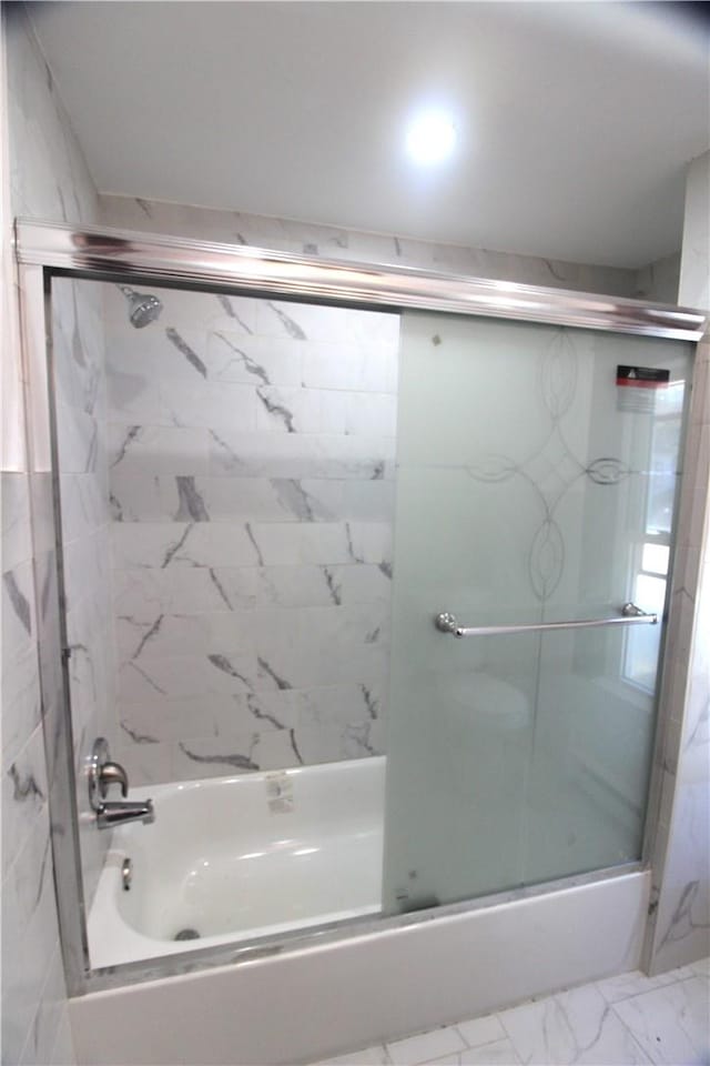 bathroom featuring shower / bath combination with glass door