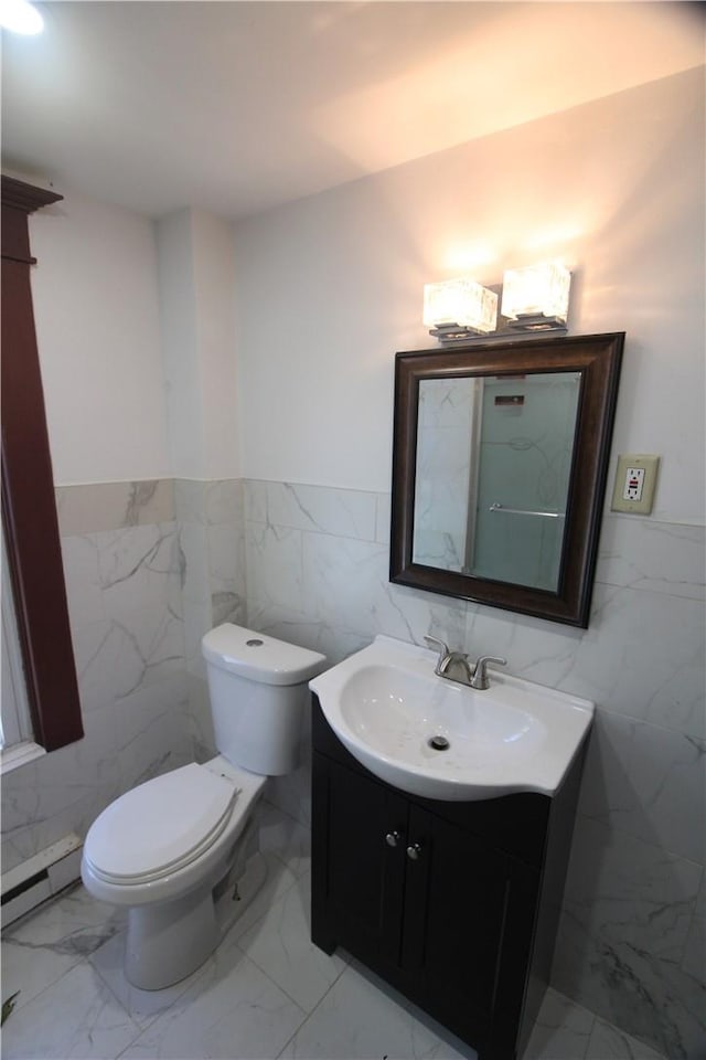 bathroom with vanity, tile walls, and a baseboard radiator