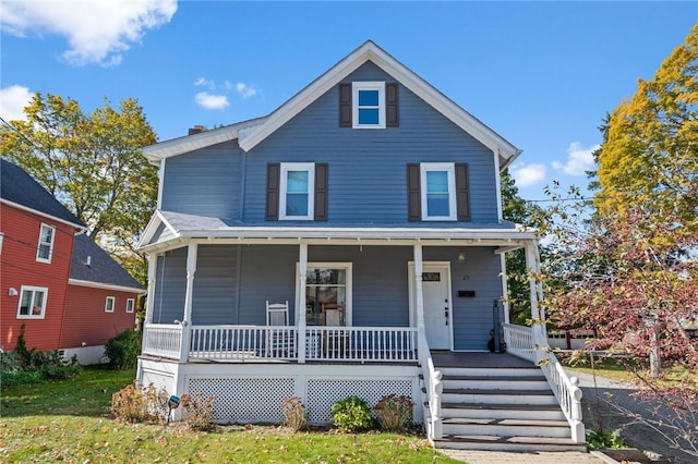 view of front of home with a porch and a front yard