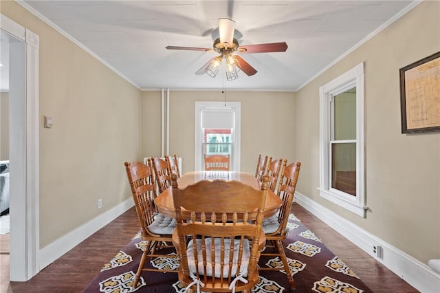 dining space with ceiling fan, dark wood-type flooring, and ornamental molding