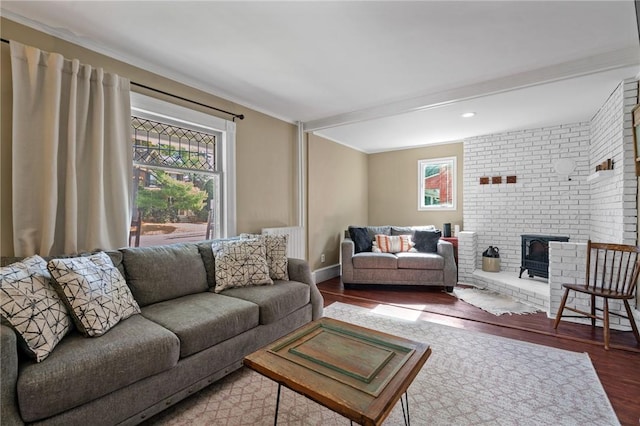 living room with hardwood / wood-style flooring and a wood stove