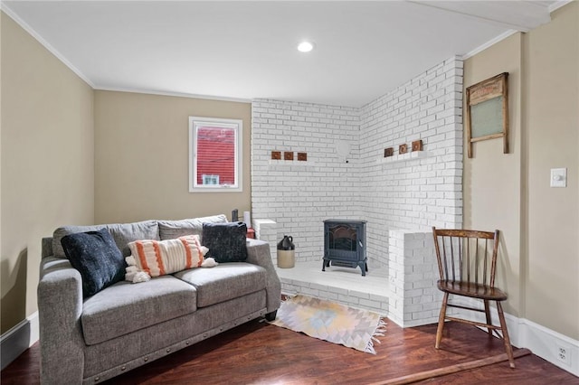 living room featuring dark hardwood / wood-style floors, a wood stove, and ornamental molding