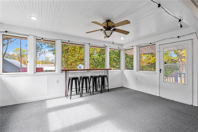 unfurnished sunroom with plenty of natural light and ceiling fan