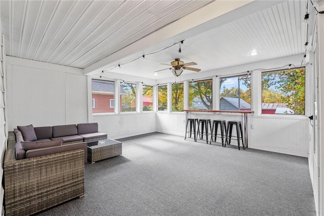 sunroom featuring ceiling fan