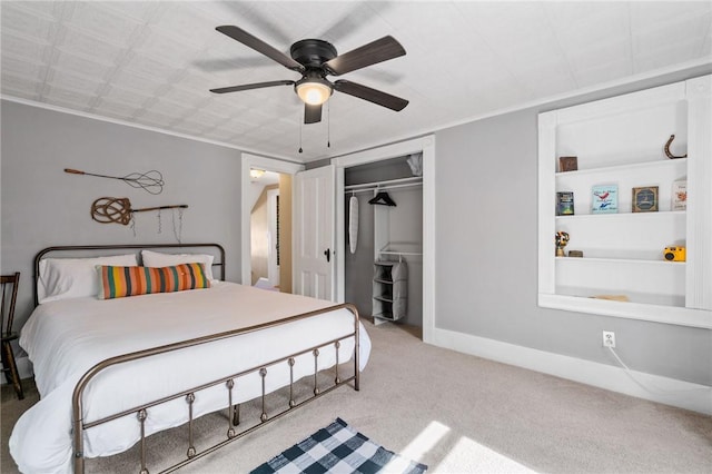 carpeted bedroom featuring ceiling fan and a closet