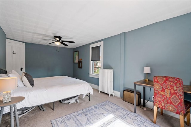 bedroom featuring ceiling fan, radiator heating unit, and light carpet