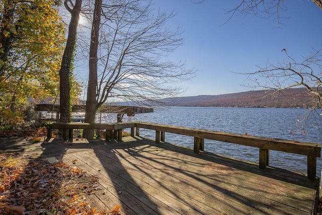 view of dock featuring a deck with water view