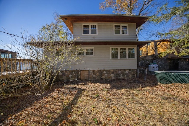 rear view of house featuring a wooden deck