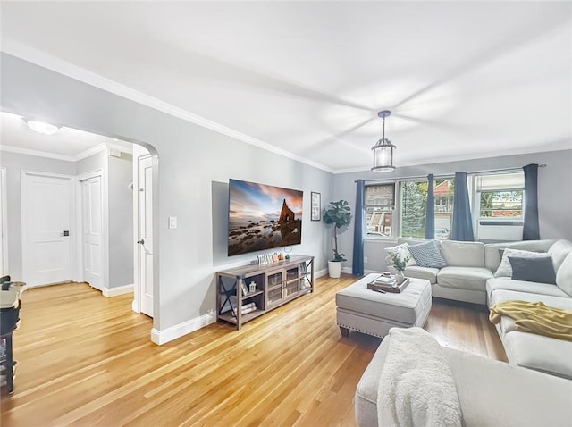 living room with hardwood / wood-style flooring and crown molding