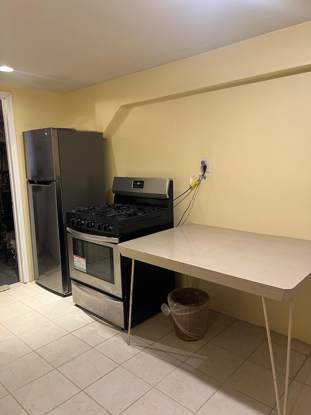 kitchen featuring light tile patterned floors and stainless steel appliances