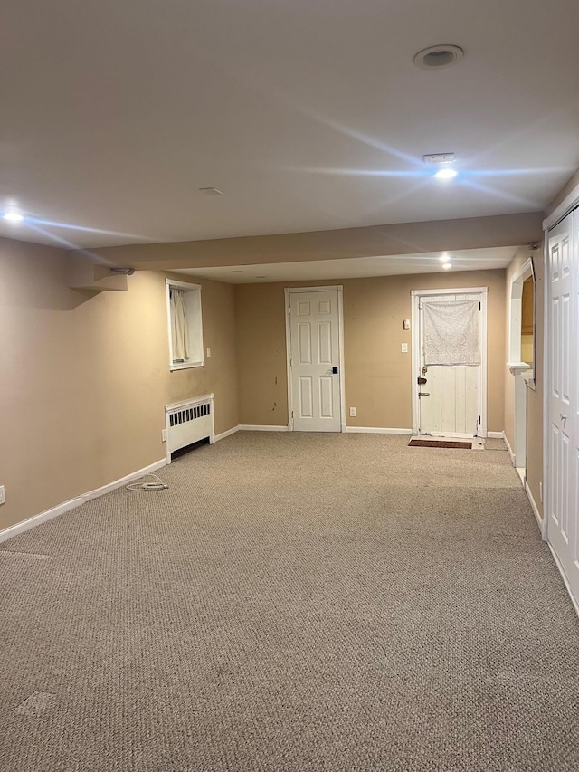 basement with carpet flooring and radiator