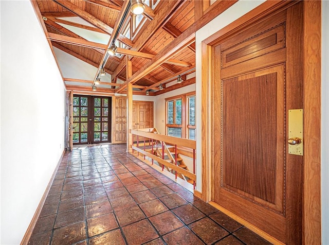 hallway with beam ceiling, high vaulted ceiling, french doors, and wooden ceiling