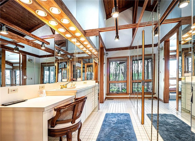 bathroom with tile patterned floors, vanity, beamed ceiling, and high vaulted ceiling