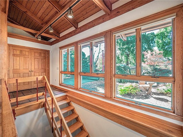 stairs featuring lofted ceiling with beams and wooden ceiling