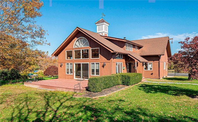 rear view of property with a yard