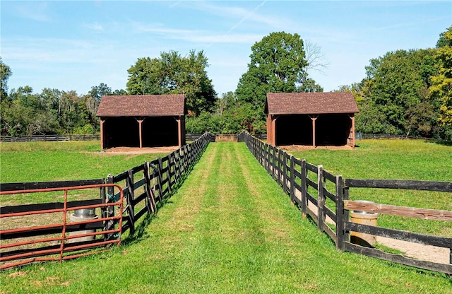 view of yard featuring a rural view and an outdoor structure